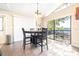 Bright dining area with a round table and chairs, offering views of the outdoor deck at 1048 Sunset Trail, Babson Park, FL 33827