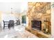 Open-concept dining area with a stone fireplace and sliding glass doors leading to outdoor patio at 1048 Sunset Trail, Babson Park, FL 33827