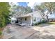 Charming single-story home featuring a spacious driveway and mature trees providing ample shade at 1048 Sunset Trail, Babson Park, FL 33827