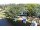 Aerial view of the lakefront house, boasting a private beach and boat dock at 1048 Sunset Trail, Babson Park, FL 33827