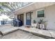 Stylish home entrance with a modern door, potted plants, and outdoor decor enhancing curb appeal at 1048 Sunset Trail, Babson Park, FL 33827
