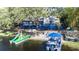 Charming lakefront home with a blue deck, sandy beach, and private boat dock at 1048 Sunset Trail, Babson Park, FL 33827