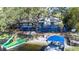 Lakefront house with spacious blue deck, boat dock, and beachside entertainment area at 1048 Sunset Trail, Babson Park, FL 33827