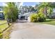 Charming single-story home with a spacious driveway, shed, and lush tropical landscaping at 1048 Sunset Trail, Babson Park, FL 33827