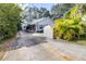 Charming single-story home with a spacious driveway, shed, and lush tropical landscaping at 1048 Sunset Trail, Babson Park, FL 33827