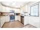 Well-lit kitchen features stainless steel appliances, granite counters and updated cabinetry at 1048 Sunset Trail, Babson Park, FL 33827