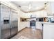 Well-lit kitchen features stainless steel appliances, granite counters and updated cabinetry at 1048 Sunset Trail, Babson Park, FL 33827