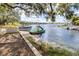 Enjoy the lake view with a pontoon boat docked on the sandy beach, with a slide to create a perfect waterfront lifestyle at 1048 Sunset Trail, Babson Park, FL 33827