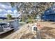 The lake view features a boat docked on the sand, a slide, and a cozy seating area, creating a perfect waterfront oasis at 1048 Sunset Trail, Babson Park, FL 33827