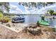 Enjoy the lake view with a pontoon boat docked on the sand, a slide, and a fire pit for cozy evenings by the water at 1048 Sunset Trail, Babson Park, FL 33827