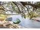 Waterfront view featuring a dock with boats, a slide, and lush greenery, creating a picturesque scene at 1048 Sunset Trail, Babson Park, FL 33827