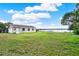 Spacious lawn leading to a lake with a shed, beautiful lakeside property at 106 Lake Sears Dr, Winter Haven, FL 33880