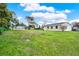 Spacious backyard featuring lush green lawn and exterior view of the home and additional storage at 106 Lake Sears Dr, Winter Haven, FL 33880