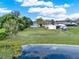 Expansive backyard featuring lush green grass and distant pond views at 106 Lake Sears Dr, Winter Haven, FL 33880