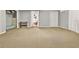 This bedroom features neutral carpet and paint plus an open doorway to another room at 106 Lake Sears Dr, Winter Haven, FL 33880