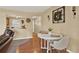 Charming dining area with a round table, neutral décor, and view into the kitchen at 106 Lake Sears Dr, Winter Haven, FL 33880