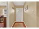 Cozy entryway featuring hardwood floors, a white door, and neutral wall paint at 106 Lake Sears Dr, Winter Haven, FL 33880