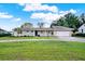 Charming single-story home with well-manicured lawn, circular driveway, and attached garage at 106 Lake Sears Dr, Winter Haven, FL 33880