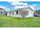A detached two car garage with white door and side entrance on a grassy lot at 106 Lake Sears Dr, Winter Haven, FL 33880