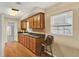 Kitchen features wooden cabinets, hardwood floors, and a window with natural light for a warm, inviting feel at 106 Lake Sears Dr, Winter Haven, FL 33880
