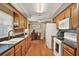 Well-lit kitchen with wooden cabinets, stainless steel appliances, and hardwood floors provides an eat-in area at 106 Lake Sears Dr, Winter Haven, FL 33880