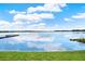 Scenic view of the lake with dock and clear reflections of the sky and clouds at 106 Lake Sears Dr, Winter Haven, FL 33880