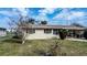 A front exterior view of a home with a well-maintained lawn at 110 Shirley Ct, Eagle Lake, FL 33839