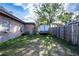 A backyard featuring a trailer, wooden fence, and some foliage at 115 Jefferson St, Lake Wales, FL 33859