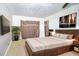 Spacious bedroom featuring a wooden bed frame, area rug, and mounted TV at 115 Jefferson St, Lake Wales, FL 33859