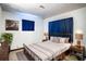 A well lit bedroom with an iron frame bed, two side tables, and a gray area rug at 115 Jefferson St, Lake Wales, FL 33859