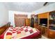 A quaint bedroom featuring a quilted bedspread and unique decor, offering a cozy retreat at 115 Jefferson St, Lake Wales, FL 33859