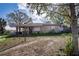 Exterior view of the home showcasing the front facade and surrounding yard at 115 Jefferson St, Lake Wales, FL 33859