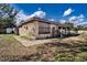 View of the exterior featuring boarded windows and an attached carport at 115 Jefferson St, Lake Wales, FL 33859