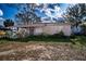 Charming single-story home with a classic front porch and mature landscaping at 115 Jefferson St, Lake Wales, FL 33859