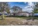 Charming single-story home with a covered porch and well-established landscaping on a sunny day at 115 Jefferson St, Lake Wales, FL 33859