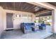 Cozy covered porch area furnished with a blue cushioned seating arrangement at 115 Jefferson St, Lake Wales, FL 33859