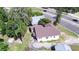 Aerial view of a cozy home near a busy road surrounded by lush trees, showing its location and surroundings at 1155 S Lake Shore Way, Lake Alfred, FL 33850