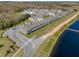 Scenic aerial view of townhomes with pond, palm trees, parking and landscaping at 1157 Blue Jay Dr, Davenport, FL 33837
