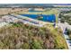 Aerial view of the property with a pond and a community golf course at 1157 Blue Jay Dr, Davenport, FL 33837