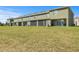 Back view of the townhome featuring a green lawn and an outdoor patio at 1157 Blue Jay Dr, Davenport, FL 33837