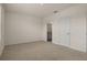 The bedroom features carpet flooring, neutral paint, and two doors leading to other rooms at 1157 Blue Jay Dr, Davenport, FL 33837