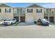 Close up view of a townhome showcasing a neutral color scheme and attached garage at 1157 Blue Jay Dr, Davenport, FL 33837