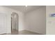 Hallway with neutral paint color features an arched entry way and tile floors at 1157 Blue Jay Dr, Davenport, FL 33837