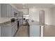The open kitchen features gray cabinets, stainless steel appliances, and an island at 1157 Blue Jay Dr, Davenport, FL 33837