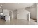 Open-concept living space featuring tile floors, staircase and an island with sink and countertop at 1157 Blue Jay Dr, Davenport, FL 33837