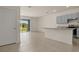 The large living room features tile floors and access to the kitchen and outdoor views at 1157 Blue Jay Dr, Davenport, FL 33837