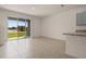 Bright living space with tile flooring and large sliding glass doors with a lake view at 1157 Blue Jay Dr, Davenport, FL 33837