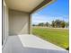 Covered patio overlooking a serene green space with palm trees and a pond at 1157 Blue Jay Dr, Davenport, FL 33837