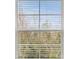 Window view overlooking an outdoor scene with trees and blue sky at 1157 Blue Jay Dr, Davenport, FL 33837