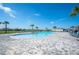 Enjoy the community pool with beautiful palm trees and plenty of lounge chairs at 144 Emanuelle Dr, Winter Haven, FL 33884